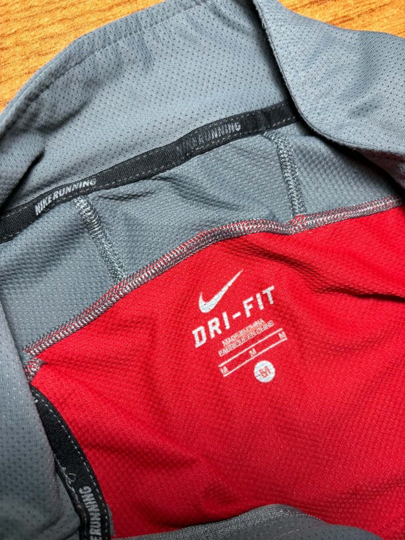 Nike Dri-FIT Quarter Zip Running Top (Category: Activewear) located in Marikina City. Submitted by maobuysstuff (Listing ID 1467010823, Image 3). Description: Authentic Nike Dri-FIT quarter zip running top - red, grey, and black colourblock design with reflective swoosh logo - Breathable mesh panels keep you cool and dry during workouts - Condition: Slightly used, some wear on the reflective strips on the arms - Pit to pit: 18.5" (fits small or m