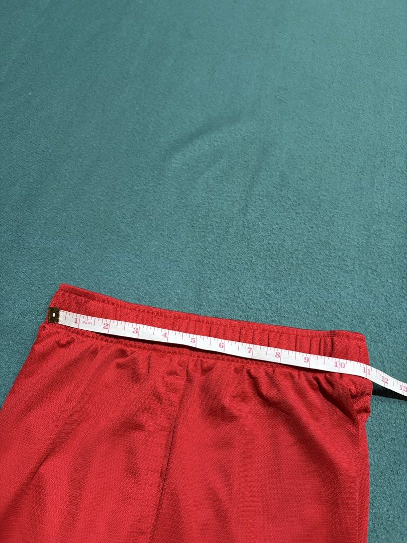 Nike Dri-FIT Red Athletic Shorts Size M (Category: Shorts) located in Guihulngan. Submitted by fbthriftgoodsniace (Listing ID 1467095522, Image 3). Description: - Brand: Nike - Color: Bright red with black Swoosh logo - Size: Medium (M) - Material: Dri-FIT moisture-wicking fabric - Features: Elastic waistband with inner adjustable drawstring - Measurements: ~11.5" flat waist across, ~21" total length - Origin: Made in Thailand - Condition: Excell