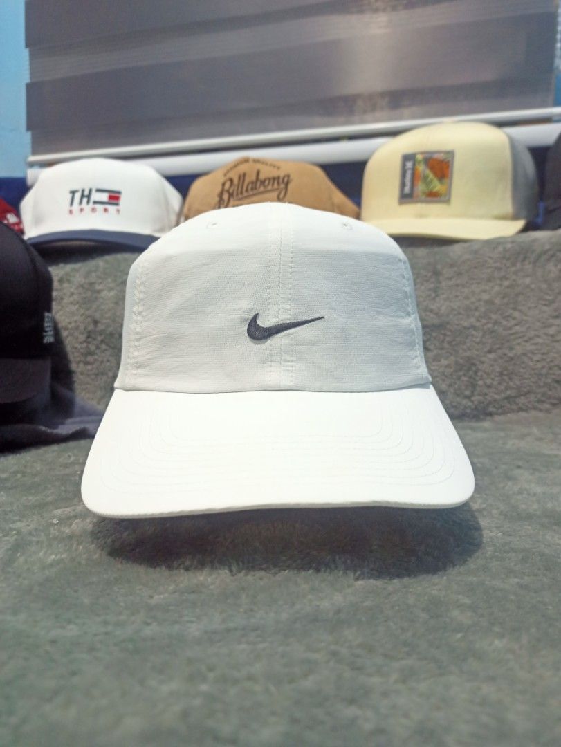 Nike Dri-FIT White Cap (Category: Caps & Hats) located in Manila. Submitted by thecomftrift.co (Listing ID 1467026209, Image 1). Description: - Authentic white Nike cap with black embroidered swoosh - Dri-FIT technology fabric keeps you dry and comfortable - Adjustable black strap closure with buckle in the back - Clean white crown and curved brim - Original Nike logo and care tags intact inside.