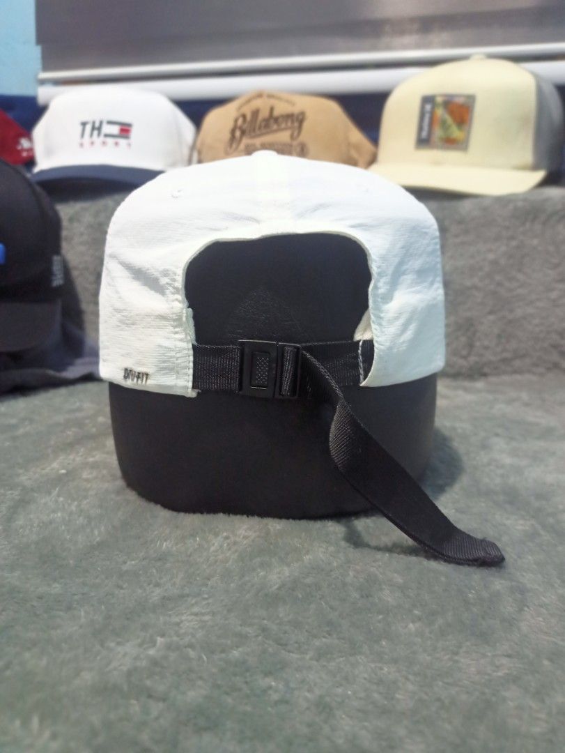 Nike Dri-FIT White Cap (Category: Caps & Hats) located in Manila. Submitted by thecomftrift.co (Listing ID 1467026209, Image 3). Description: - Authentic white Nike cap with black embroidered swoosh - Dri-FIT technology fabric keeps you dry and comfortable - Adjustable black strap closure with buckle in the back - Clean white crown and curved brim - Original Nike logo and care tags intact inside.