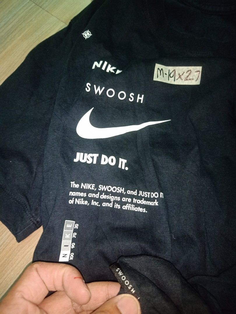 Nike Just Do It Black T-Shirt Size M (Category: Tshirts & Polo Shirts ) located in Cavite. Submitted by nigo1993 (Listing ID 1467090823, Image 3). Description: - Brand: Nike - Color: Classic Black - Design: Large front graphic with Nike, Swoosh, and Just Do It text - Fit: Regular fit, short sleeves, crew neck - Size: Medium (Measured: 19" width x 27" length) - Condition: Pre-owned, well-maintained everyday tee.