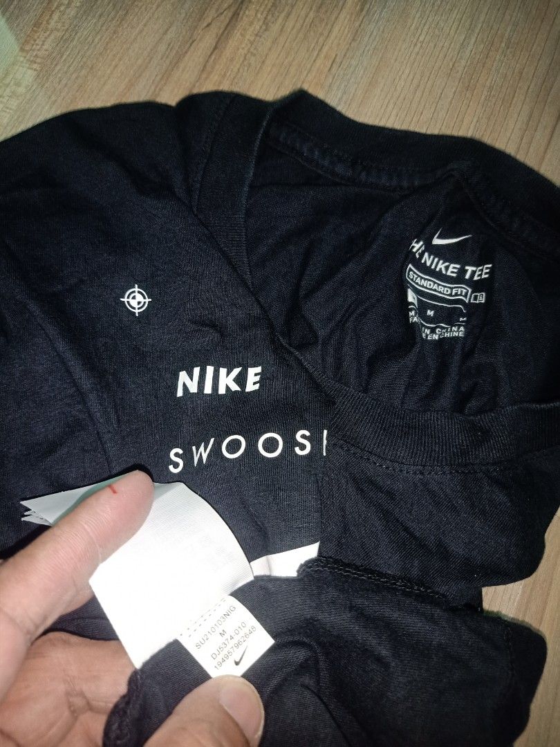 Nike Just Do It Black T-Shirt Size M (Category: Tshirts & Polo Shirts ) located in Cavite. Submitted by nigo1993 (Listing ID 1467090823, Image 2). Description: - Brand: Nike - Color: Classic Black - Design: Large front graphic with Nike, Swoosh, and Just Do It text - Fit: Regular fit, short sleeves, crew neck - Size: Medium (Measured: 19" width x 27" length) - Condition: Pre-owned, well-maintained everyday tee.