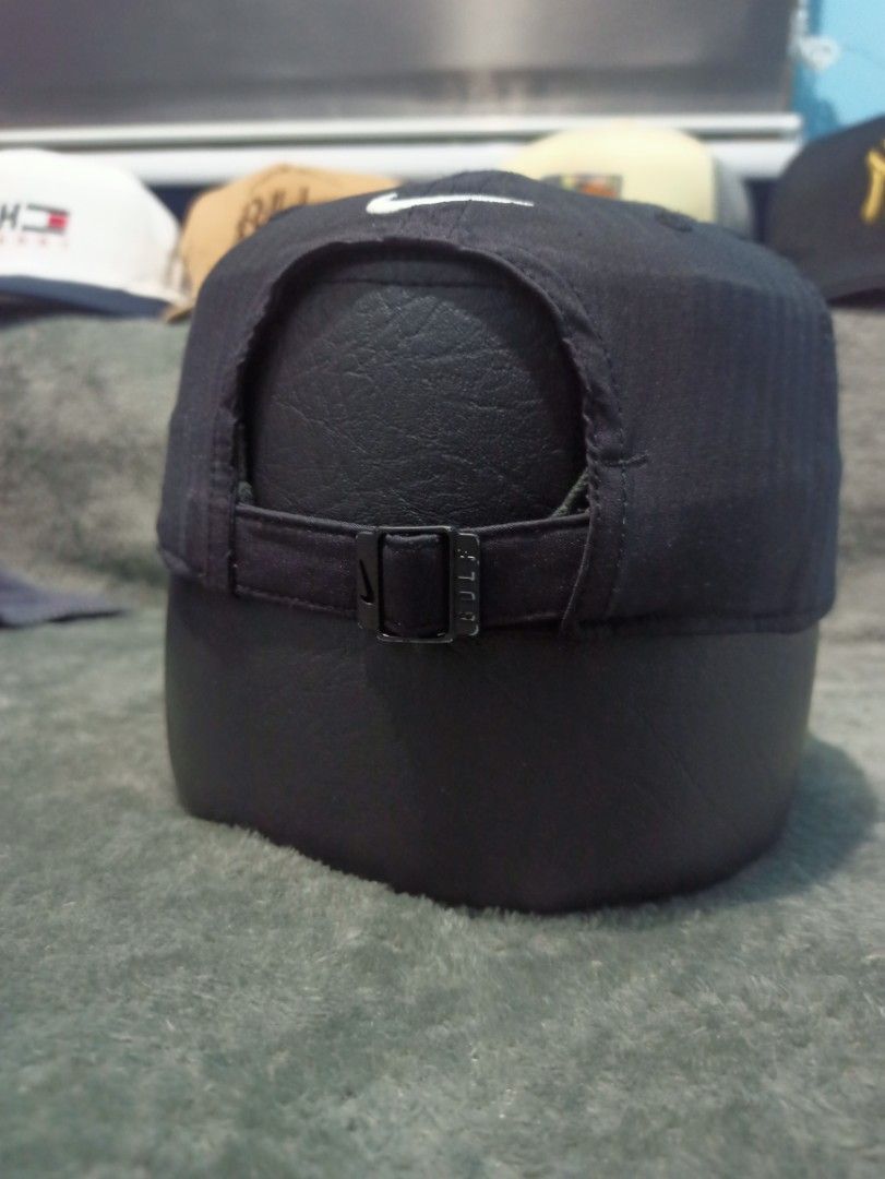 Nike Legacy91 Dri-Fit Black Cap (Category: Caps & Hats) located in Manila. Submitted by thecomftrift.co (Listing ID 1467026077, Image 3). Description: - Brand: Nike Legacy91 - Color: Black with white embroidered swoosh on front and back - Material: 100% polyester with moisture-wicking Dri-Fit technology - Closure: Adjustable metal buckle stamped with GOLF - Condition: Clean, well-maintained overall.