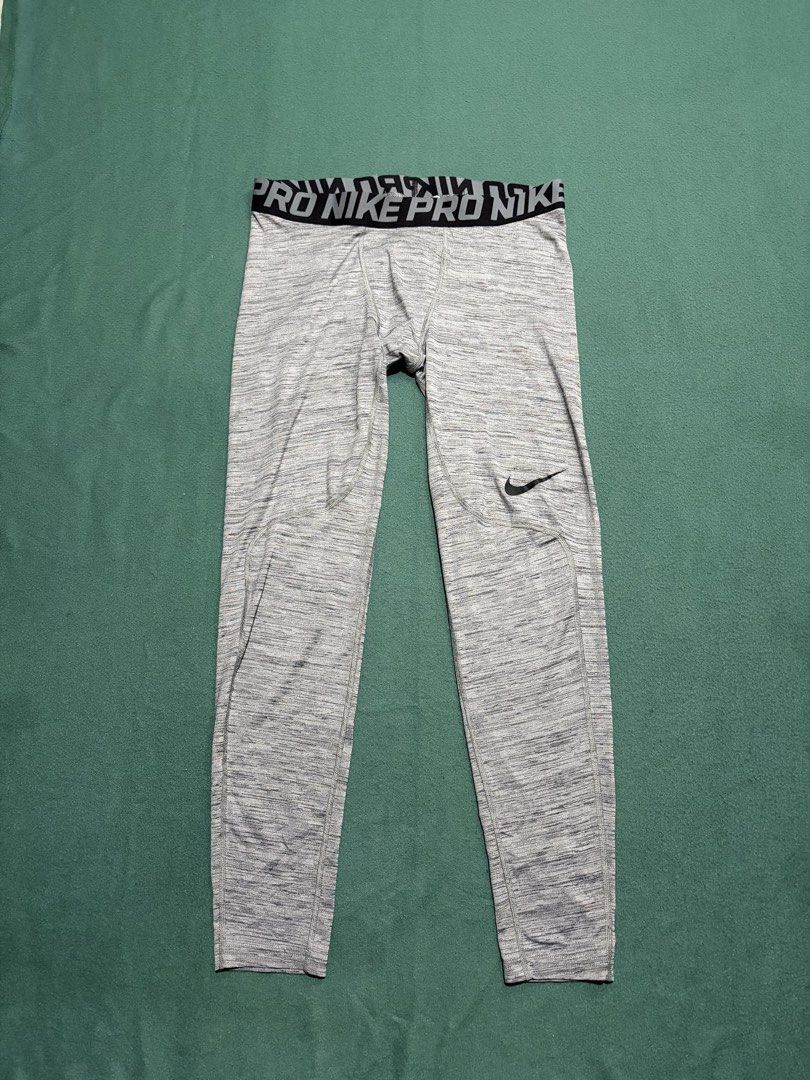 Nike Pro Dri-FIT Compression Grey Heather Leggings (Category: Activewear) located in Guihulngan. Submitted by fbthriftgoodsniace (Listing ID 1467090439, Image 1). Description: Nike Pro compression leggings in a grey heather colorway. Dri-FIT technology helps keep you dry and comfortable during workouts. Branded elastic waistband, iconic swoosh logo near the left knee. Size L tag printed on the inside. Durable fabric with reinforced stitching arou