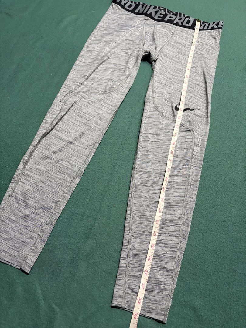Nike Pro Dri-FIT Compression Grey Heather Leggings (Category: Activewear) located in Guihulngan. Submitted by fbthriftgoodsniace (Listing ID 1467090439, Image 2). Description: Nike Pro compression leggings in a grey heather colorway. Dri-FIT technology helps keep you dry and comfortable during workouts. Branded elastic waistband, iconic swoosh logo near the left knee. Size L tag printed on the inside. Durable fabric with reinforced stitching arou