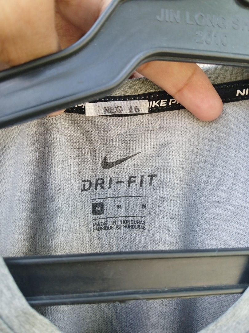 Nike Pro Dri-FIT Grey Tank Top Size M (Category: Activewear) located in Manila. Submitted by thrift_sixty (Listing ID 1467000071, Image 3). Description: Nike Pro sleeveless workout top in grey heather. Size M, made in Honduras. Dri-FIT moisture-wicking fabric keeps you dry during training sessions. Signature Nike swoosh logo on the chest and small Nike Pro branding near the hem. Body made from 93% polyester and 7% spandex. Lightweight, stretchy m