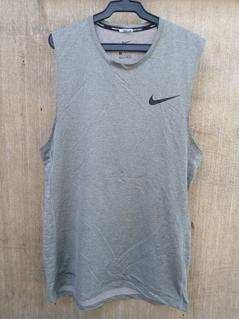 Nike Pro Dri-FIT Grey Tank Top Size M (Category: Activewear) located in Manila. Submitted by thrift_sixty (Listing ID 1467000071, Image 1). Description: Nike Pro sleeveless workout top in grey heather. Size M, made in Honduras. Dri-FIT moisture-wicking fabric keeps you dry during training sessions. Signature Nike swoosh logo on the chest and small Nike Pro branding near the hem. Body made from 93% polyester and 7% spandex. Lightweight, stretchy m