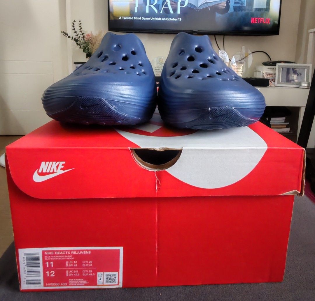 Nike ReactX Rejuven8 Blue Void Indigo Burst (Category: Sneakers) located in Mandaluyong City. Submitted by simply_g0529 (Listing ID 1466984839, Image 3). Description: - Brand: Nike - Model: ReactX Rejuven8 Slip-On Clogs - Colorway: Blue Void and Indigo Burst - Size: US Men's 11 - Condition: Brand new, never worn, pristine condition - Inclusions: Original red Nike shoebox - Features: Ventilation holes on upper, glossy blue side Swoosh, chunky ridg