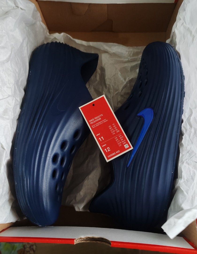 Nike ReactX Rejuven8 Blue Void Indigo Burst (Category: Sneakers) located in Mandaluyong City. Submitted by simply_g0529 (Listing ID 1466984839, Image 2). Description: - Brand: Nike - Model: ReactX Rejuven8 Slip-On Clogs - Colorway: Blue Void and Indigo Burst - Size: US Men's 11 - Condition: Brand new, never worn, pristine condition - Inclusions: Original red Nike shoebox - Features: Ventilation holes on upper, glossy blue side Swoosh, chunky ridg