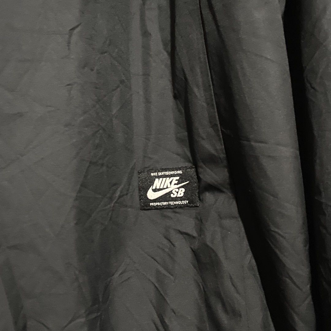Nike SB Black Coaches Jacket Size L (Category: Coats, Jackets and Outerwear) located in Manila. Submitted by seramisu (Listing ID 1467073825, Image 3). Description: - Authentic Nike SB coach jacket in black, size Large - Snap button closure with classic collar neckline - Adjustable drawstring hem for a custom fit - Distinct white and gold 'SB' graphic printed on the left chest - Official Nike SB inner tag and branding - Versatile outer layer, gre