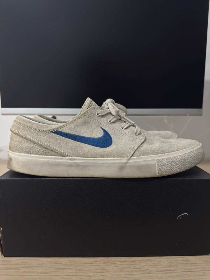 Nike SB Stefan Janoski Grey Blue (Category: Sneakers) located in Caloocan City. Submitted by leandroroman (Listing ID 1467130231, Image 1). Description: - Brand: Nike SB Stefan Janoski - Color: Light grey suede with blue embroidered swoosh - Sole: Classic white rubber midsole with intact blue branded insoles - Condition: Pre-owned with minor scuffs and dirt marks from general wear; still plenty of life left for skating or daily casual use - Inclu