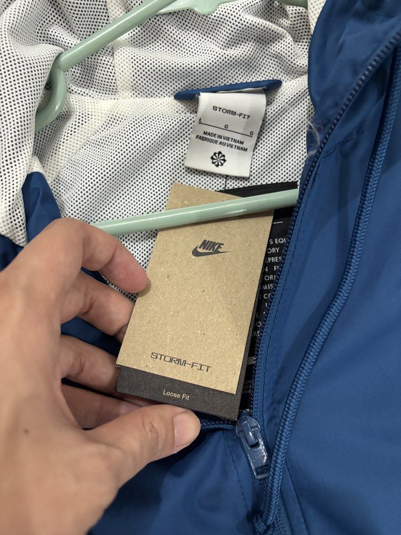 Nike Storm-FIT Windrunner Jacket Blue White Size L (Category: Coats, Jackets and Outerwear) located in Bacoor. Submitted by makibao24 (Listing ID 1467068287, Image 2). Description: - Brand: Nike Storm-FIT Windrunner jacket - Color: Blue and White - Size: Men's Large (Style Code: HV8370-476) - Condition: Brand new with original tags attached - Features: Loose fit, full zip closure, hood, zippered pockets, and inner mesh lining Brandnew Size Large 