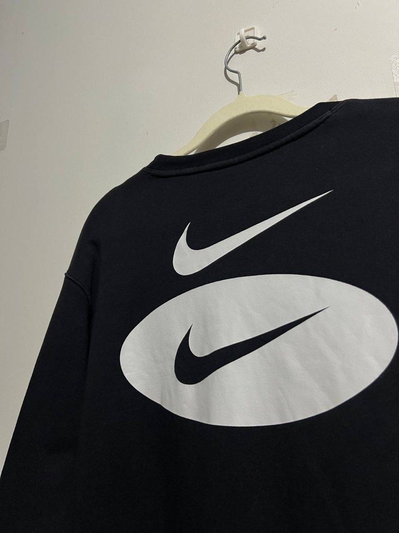 Nike Swoosh Oval Logo Black Sweatshirt (Category: Coats, Jackets and Outerwear) located in Bacoor. Submitted by theneedwash (Listing ID 1467132933, Image 3). Description: - Brand: Nike - Style Code: DM5461-010 - Size: Medium - Color: Black - Design: Embroidered layered Swoosh & oval logo on chest, oversized printed logo on back shoulders - Details: Ribbed crew neck, cuffs, and hem with thick fleece interior.