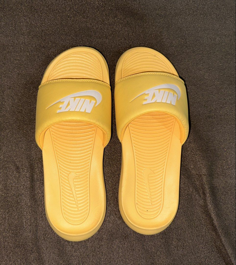 Nike Victoria One Slides Yellow Size 8 (Category: Flats & Sandals) located in Manila. Submitted by klmesco (Listing ID 1467058818, Image 1). Description: - Brand: Nike - Color: Bright yellow with white branding - Size: US 8 / UK 5.5 / EUR 39 - Minor wear on soles, original price sticker on bottom of one sandal - RFS: Decluttering, need funds 🥹.