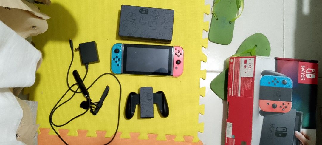 Nintendo Switch Mario Edition Console with Original Box (Category: Nintendo) located in Caloocan City. Submitted by nielmail.com (Listing ID 1467150296, Image 3). Description: - Nintendo Switch console with Neon Blue and Neon Pink Joy-Cons - Features the special Mario edition dock - Includes Joy-Con grip, power adapter, and two wrist straps - Comes with original retail box - Clean screen with all buttons and ports fully working - Plug and play, r