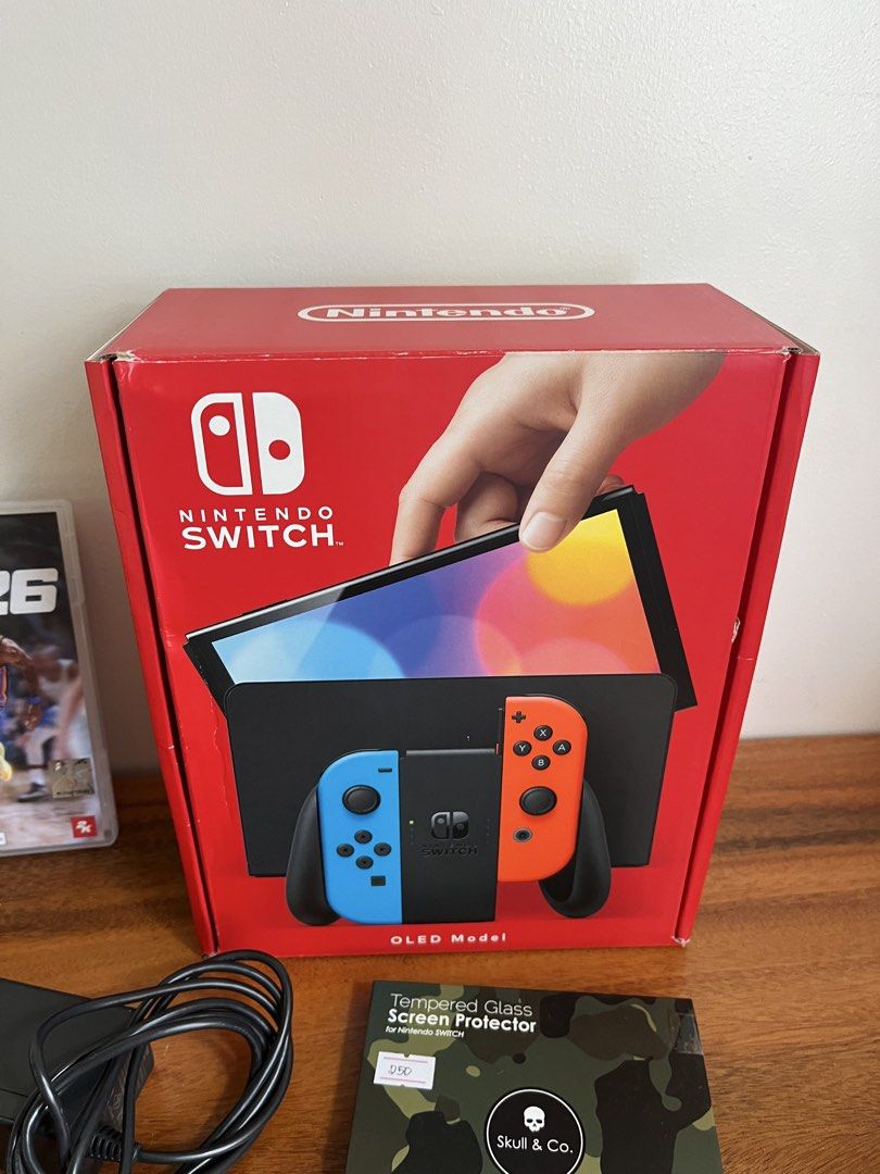 Nintendo Switch OLED Bundle (Category: Nintendo) located in Bacolod City. Submitted by ejdp_24 (Listing ID 1467108642, Image 2). Description: Nintendo Switch OLED Bundle ( Neon Blue and Red ) Complete accessories with box and games - Original Box - Dock ( Never been used 😅 ) - Original grip and straps ( Never used din ) - HDMI Cable and AC Adapter - Skull & Co. Protective Case Games: - Need for Speed: Hot Pursuit Remastered - NBA 2K24 - Naruto S