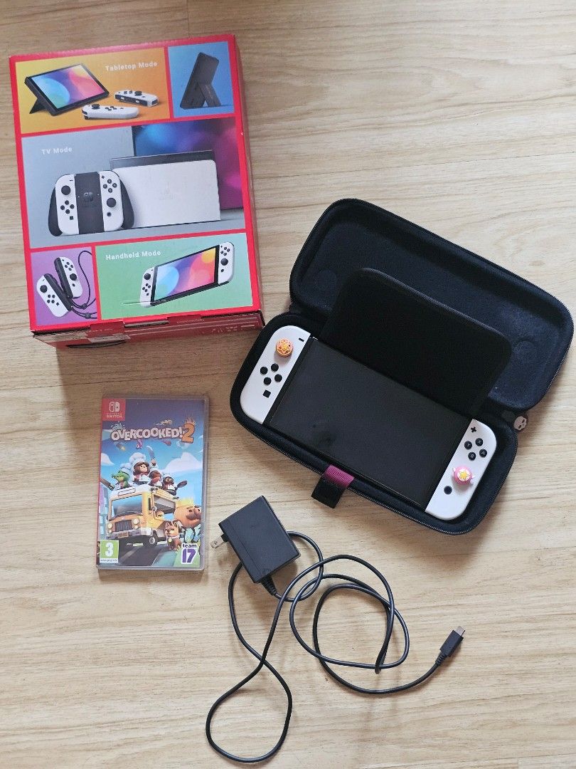 Nintendo Switch OLED Model White with Case and Overcooked 2 (Category: Nintendo) located in Dasmarinas. Submitted by katesky (Listing ID 1467007024, Image 1). Description: - Nintendo Switch OLED Console (White) with clean screen - Original box and power adapter included - Overcooked 2 physical game cartridge - Everything in photos is included in this bundle - Meet up only at SM Dasmariñas or Eton Centris, Quezon City.