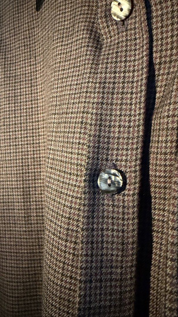 Novel Houndstooth Button-Up Long Sleeve Shirt (Category: Formal Shirts) located in Makati City. Submitted by tomascz (Listing ID 1466983520, Image 3). Description: Novel brand button-up shirt in a aubergine and black houndstooth pattern. Classic collar, front button closure, and single chest pocket. Unique gathered detail along the sleeves gives it a distinct shape. Soft textured fabric with marbled grey buttons. Pick up from Makati care of buyer