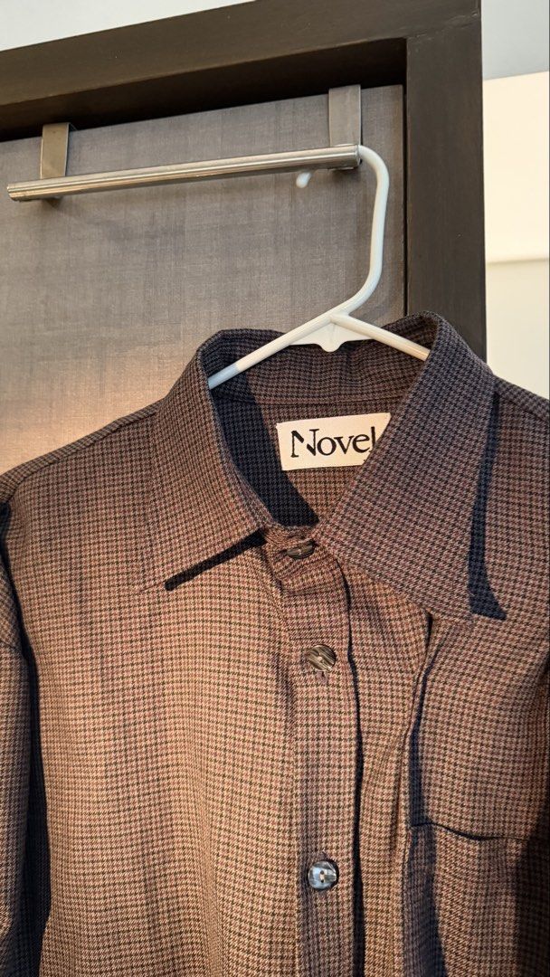 Novel Houndstooth Button-Up Long Sleeve Shirt (Category: Formal Shirts) located in Makati City. Submitted by tomascz (Listing ID 1466983520, Image 2). Description: Novel brand button-up shirt in a aubergine and black houndstooth pattern. Classic collar, front button closure, and single chest pocket. Unique gathered detail along the sleeves gives it a distinct shape. Soft textured fabric with marbled grey buttons. Pick up from Makati care of buyer