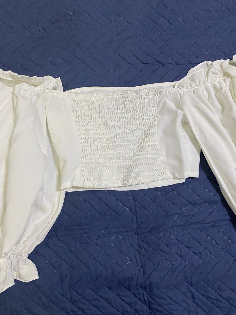 Off Shoulder Flounce Sleeve Crop Top (Category: Sleeveless) located in Manila. Submitted by escherichiaa (Listing ID 1467141246, Image 3). Description: - Brand: SHEIN Unity - Style: Off-shoulder crop top with dramatic long flounce sleeves and ruffled cuffs - Color: Crisp white - Size: XS (EU 34, US 2) - Material: 100% polyester - Fit: Smocked back panel for a snug and comfortable fit - Perfect for: Casual outings or date nights.