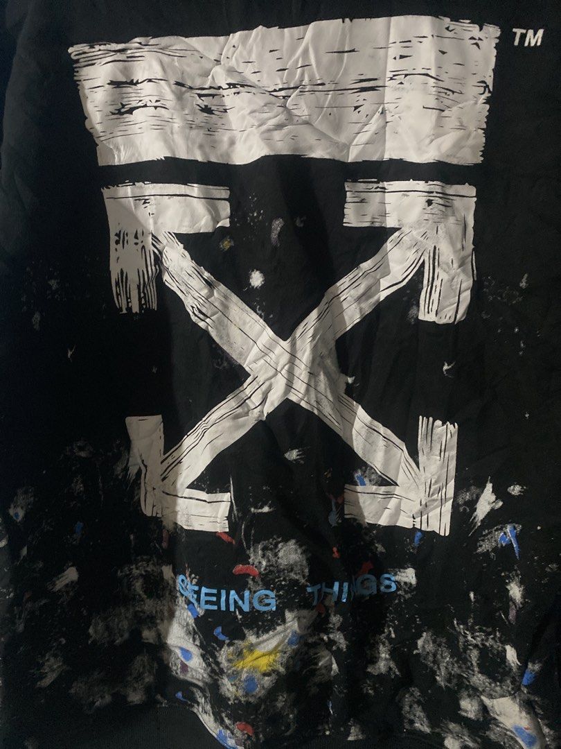 Off-White Paint Splatter Seeing Things Black Hoodie (Category: Hoodies) located in Manila. Submitted by zhu.finds (Listing ID 1467043615, Image 3). Description: - Brand: Off-White (Virgil Abloh) - Color: Black with white paint splatter - Design: Signature diagonal stripes on sleeves & large arrow graphic on back with blue 'SEEING THINGS' text - Fit: Relaxed fit - Material: Premium heavyweight cotton - Condition: Great streetwear piece - Missing L
