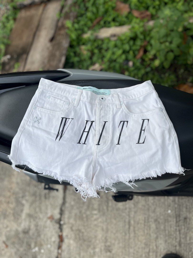 Off-White White Denim Shorts Size 38 Size Small (Category: Shorts) located in Tacloban City. Submitted by luxbag_phhh (Listing ID 1467006593, Image 1). Description: - Brand: Off-White Authentic - Color: White with bold black 'WHITE' lettering - Size: 38 (Interior tag) size Small - Material: 100% polyester denim fabric - Design: Raw frayed hem, signature mint green interior/exterior labels, branded metal buttons and rivets - Condition: Excellent p