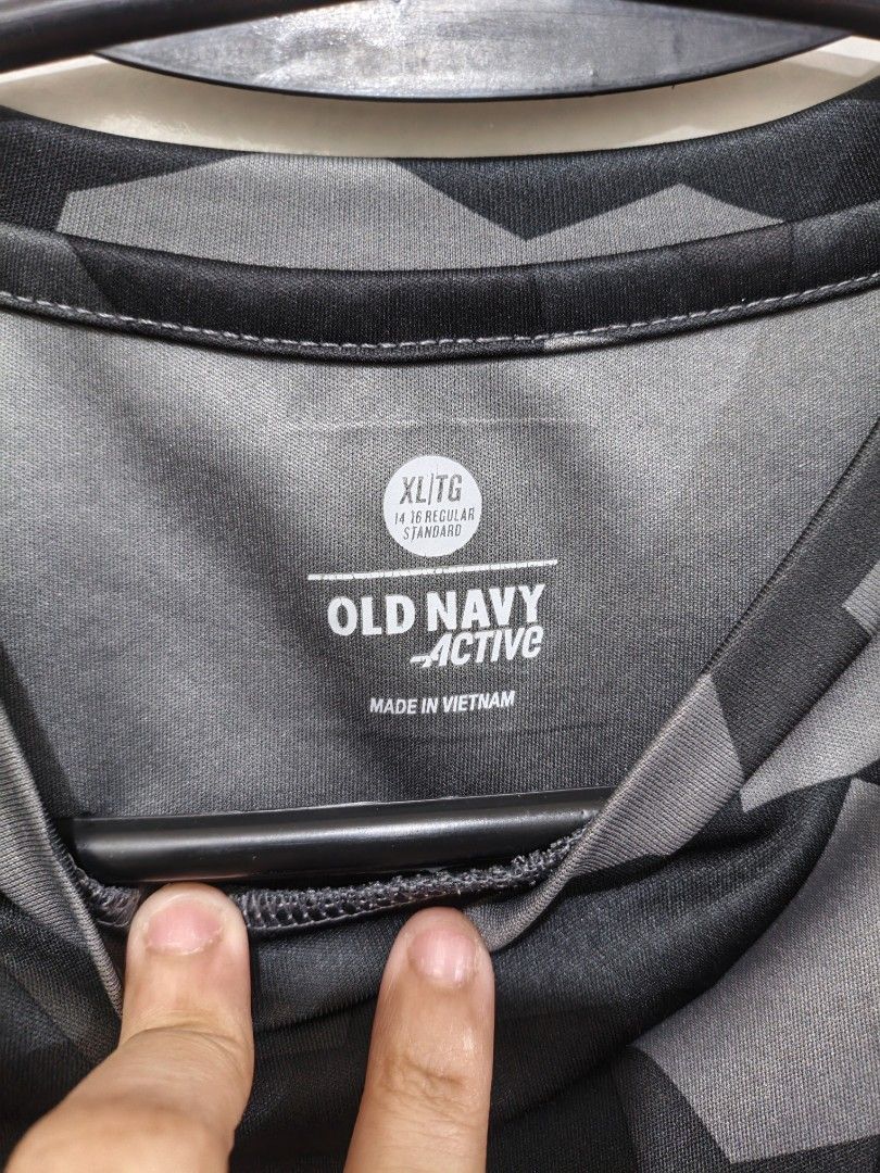 Old Navy Active Camo Athletic T-Shirt (Category: Shirts) located in Quezon City. Submitted by closeta38 (Listing ID 1467000525, Image 3). Description: - Brand: Old Navy Active - Design: Black and grey geometric camo print - Features: Short sleeves, crew neck, small reflective logo on chest - Material: Lightweight and breathable, perfect for gym or running - Size: XL (14-16) regular standard youth size - Origin: Made in Vietnam.