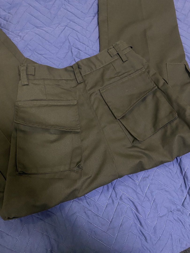 Olive Green Cargo Pants with Adjustable Waist Buckles (Category: Jeans) located in Manila. Submitted by escherichiaa (Listing ID 1467116401, Image 2). Description: - Color: Olive green - Fit: Wide leg with front pleats - Details: Utility pockets on sides and back, adjustable side waist buckles - Closure: Button closure - Material: Sturdy twill fabric - Condition: Excellent, clean with no flaws.