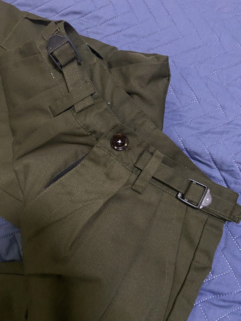 Olive Green Cargo Pants with Adjustable Waist Buckles (Category: Jeans) located in Manila. Submitted by escherichiaa (Listing ID 1467116401, Image 3). Description: - Color: Olive green - Fit: Wide leg with front pleats - Details: Utility pockets on sides and back, adjustable side waist buckles - Closure: Button closure - Material: Sturdy twill fabric - Condition: Excellent, clean with no flaws.