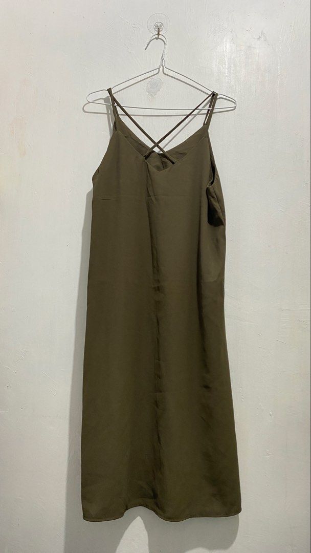 Olive green spaghetti strap midi slip dress (Category: Dresses) located in Ozamiz City. Submitted by carisclosetcleanup (Listing ID 1467124664, Image 1). Description: - Color: Olive green - Length: Midi (falls below the knee) - Material: Lightweight, silky fabric - Design: V-neckline with thin criss-cross back straps - Finish: Clean hem and smooth all around - Styling: Easy to dress up with heels or casual with sandals - Season: Versatile earth t