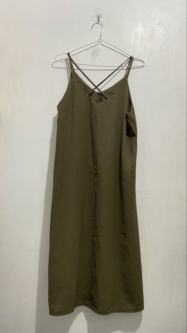 Olive green spaghetti strap midi slip dress (Category: Dresses) located in Ozamiz City. Submitted by carisclosetcleanup (Listing ID 1467124664, Image 3). Description: - Color: Olive green - Length: Midi (falls below the knee) - Material: Lightweight, silky fabric - Design: V-neckline with thin criss-cross back straps - Finish: Clean hem and smooth all around - Styling: Easy to dress up with heels or casual with sandals - Season: Versatile earth t