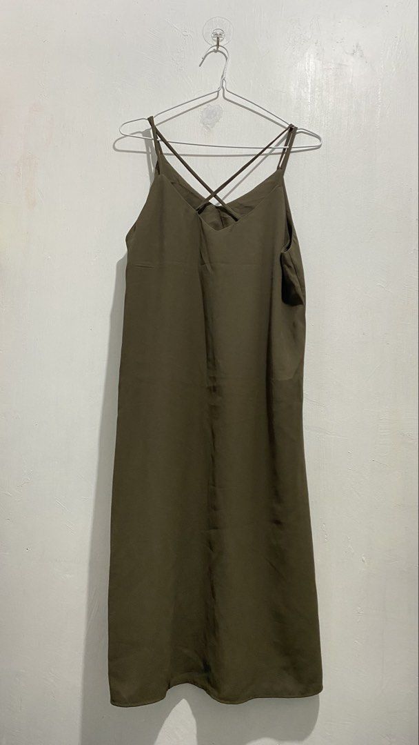 Olive green spaghetti strap midi slip dress (Category: Dresses) located in Ozamiz City. Submitted by carisclosetcleanup (Listing ID 1467124664, Image 2). Description: - Color: Olive green - Length: Midi (falls below the knee) - Material: Lightweight, silky fabric - Design: V-neckline with thin criss-cross back straps - Finish: Clean hem and smooth all around - Styling: Easy to dress up with heels or casual with sandals - Season: Versatile earth t