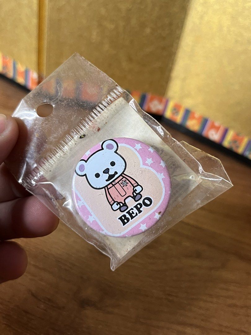 One Piece Bepo Bear Pin Badge Button (Category: Character Goods) located in Gapan. Submitted by lunashop14 (Listing ID 1467094422, Image 1). Description: - Character: Bepo (One Piece) in pink clothes - Design: Pink background with white stars and 'Bepo' lettering - Condition: Brand new, still sealed in original clear plastic packaging - Type: Collectible round pin badge for anime fans - Shipping: Ships securely from a trusted Carousell seller.
