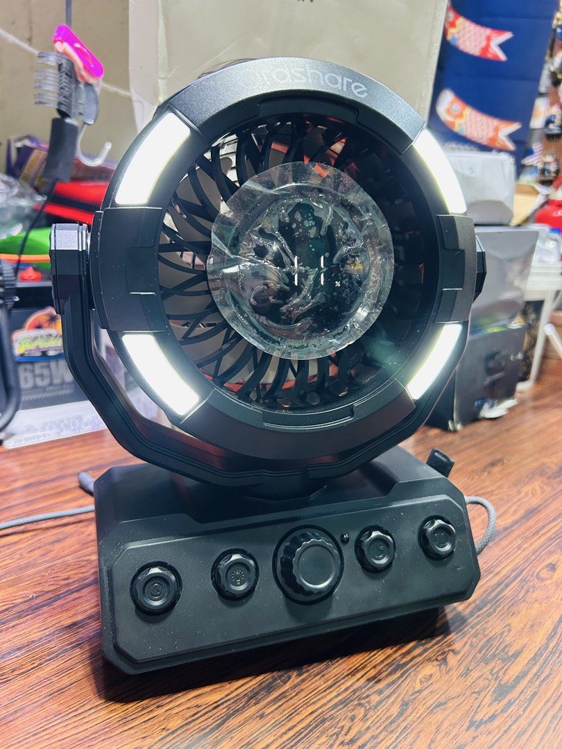 Orashare Strong Wind Camping Fan with LED Light (Category: Fans) located in Manila. Submitted by starbalesukandjapansurplus (Listing ID 1466977858, Image 2). Description: - Brand: Orashare camping fan in stylish black - Build: Heavy-duty and durable construction - Lighting: Built-in LED ring light around the fan head - Controls: Multi-function control knobs located on the base - Battery: Massive 20000mAh capacity (per packaging) - Condition: Incl