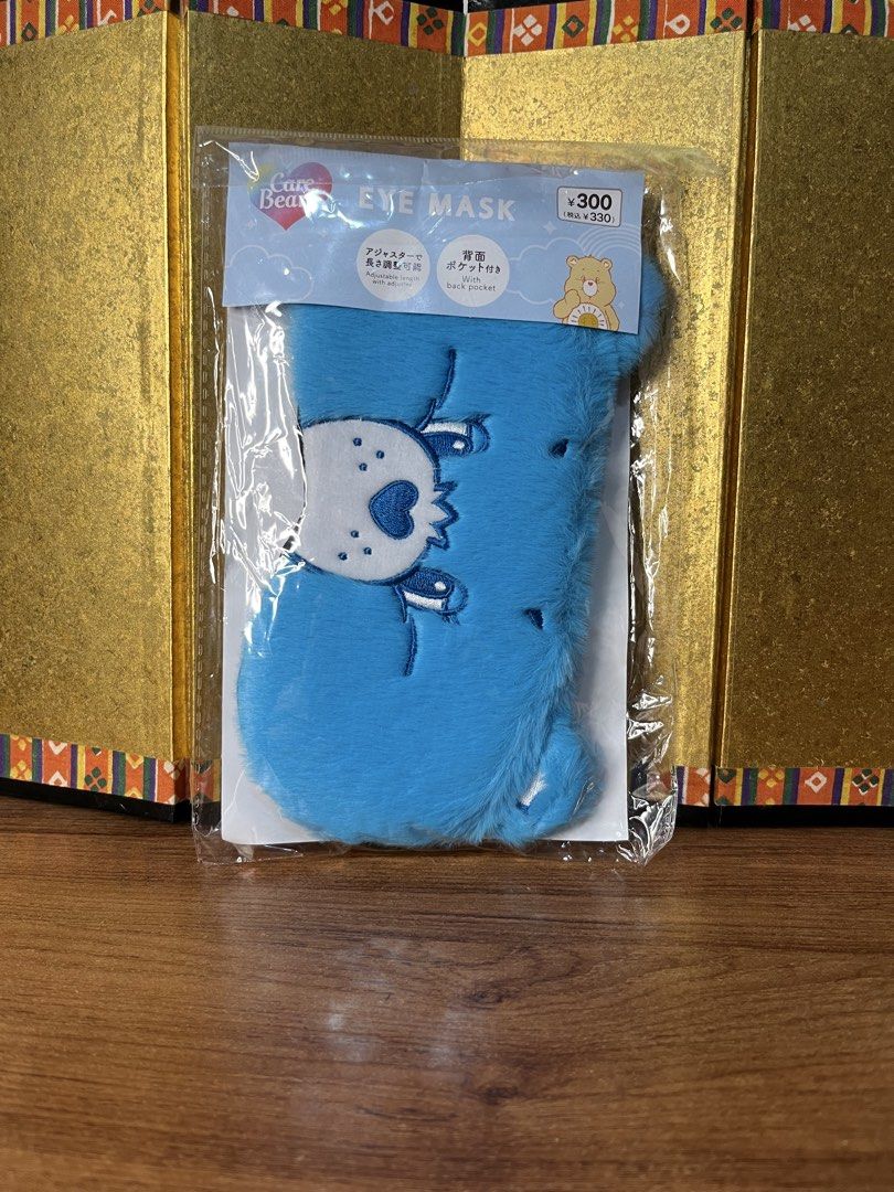Original Care Bears Blue Face Eye Mask (Category: Face Care) located in Gapan. Submitted by lunashop14 (Listing ID 1467164174, Image 1). Description: - Authentic Care Bears blue plush eye mask - Features a cute embroidered face design - Equipped with an adjustable strap and slider for comfort - Convenient built-in pocket on the back side - Made from ultra-soft furry material - Brand new, factory sealed in original plastic packaging with tags.