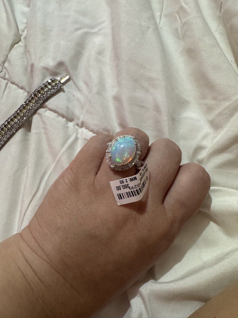 Oval Opal Ring with Diamond Halo and Tag (Category: Rings) located in Manila. Submitted by hackelina (Listing ID 1467029861, Image 2). Description: - Stunning large oval opal with vibrant multicolored play-of-color - Beautiful halo of sparkling diamonds and accent stones on the band - Crafted in a sleek silver-tone metal setting - Includes original tag (Style No. RG-2269, Gross Weight: 4.70, Net Weight: 2.93) - Beautifully packed in a plush beige