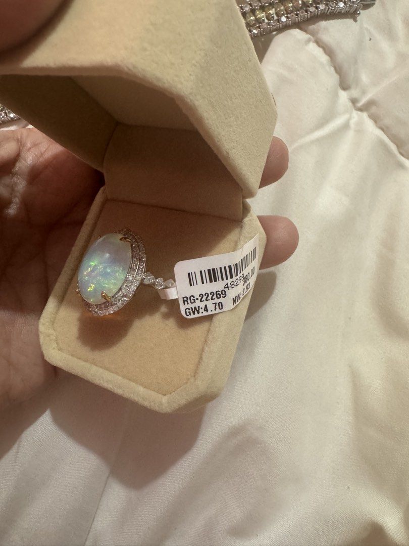 Oval Opal Ring with Diamond Halo and Tag (Category: Rings) located in Manila. Submitted by hackelina (Listing ID 1467029861, Image 3). Description: - Stunning large oval opal with vibrant multicolored play-of-color - Beautiful halo of sparkling diamonds and accent stones on the band - Crafted in a sleek silver-tone metal setting - Includes original tag (Style No. RG-2269, Gross Weight: 4.70, Net Weight: 2.93) - Beautifully packed in a plush beige