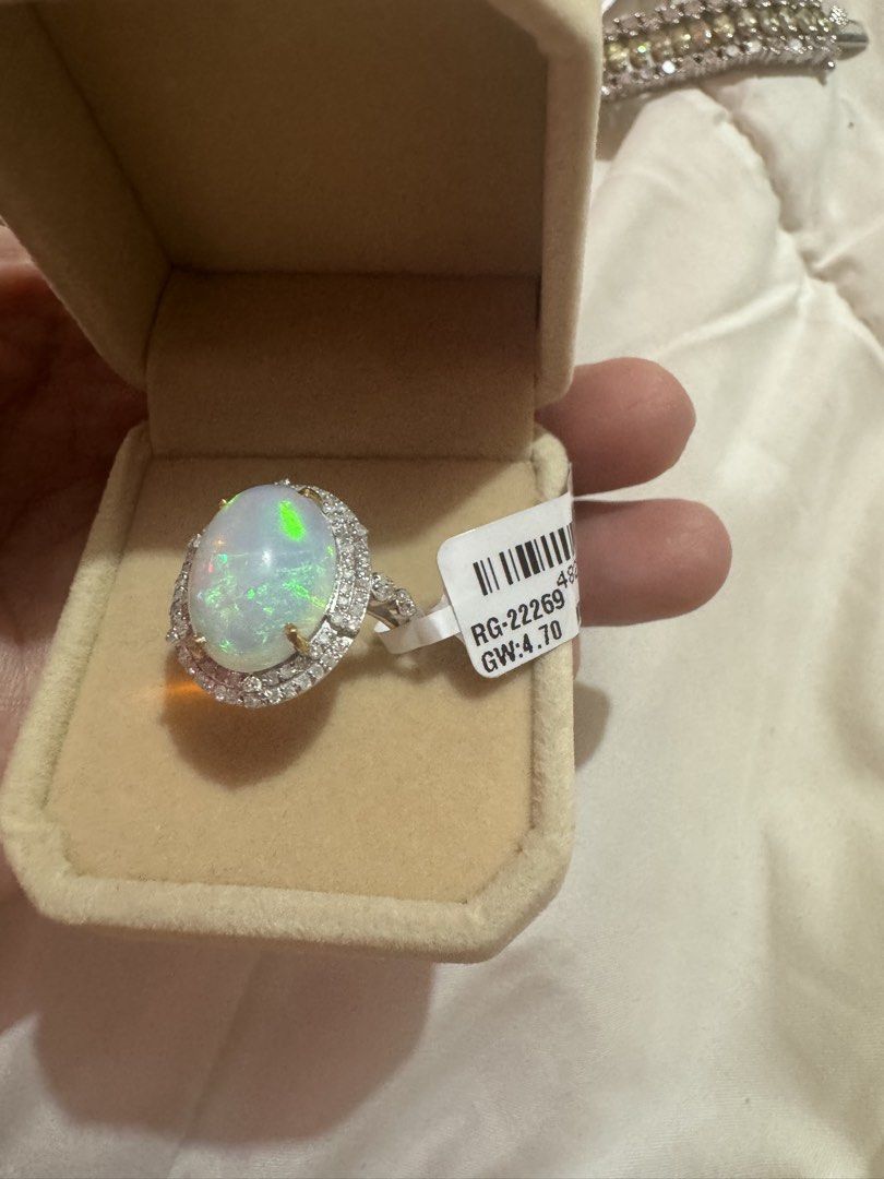 Oval Opal Ring with Diamond Halo and Tag (Category: Rings) located in Manila. Submitted by hackelina (Listing ID 1467029861, Image 1). Description: - Stunning large oval opal with vibrant multicolored play-of-color - Beautiful halo of sparkling diamonds and accent stones on the band - Crafted in a sleek silver-tone metal setting - Includes original tag (Style No. RG-2269, Gross Weight: 4.70, Net Weight: 2.93) - Beautifully packed in a plush beige