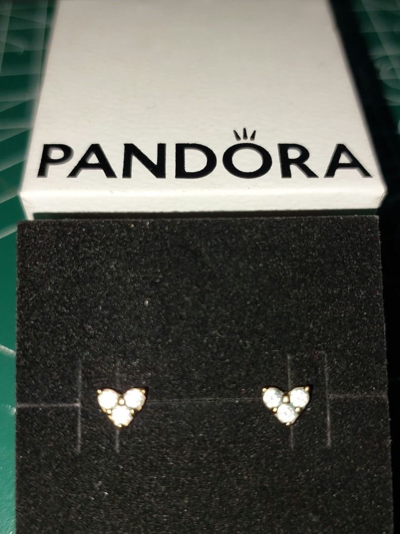 Pandora Triple Stone Heart Stud Earrings (Category: Earrings) located in Pasig City. Submitted by annvital_0 (Listing ID 1467146400, Image 1). Description: - Material: 14k gold-plated finish - Design: Heart-shaped studs with three sparkling round stones - Closure: Includes matching heart-shaped butterfly backs - Style: Dainty, refined, and versatile for everyday wear - Reason for selling: decluttering my jewelry collection .