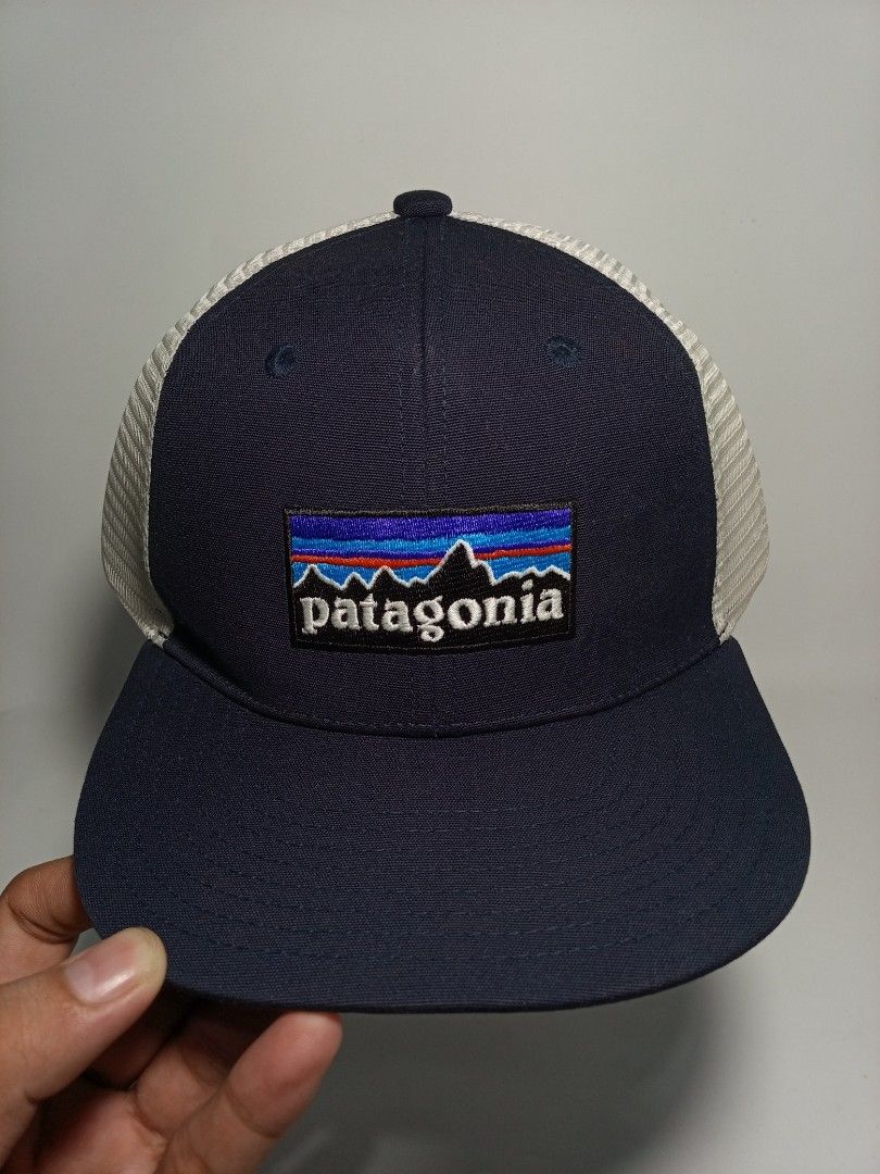 Patagonia Trucker Snapback Hat Navy Blue (Category: Caps & Hats) located in Lucena. Submitted by sanera_23 (Listing ID 1467033734, Image 1). Description: -Fits to small Adult - Brand: Patagonia - Style: Trucker hat / Snapback - Color: Navy blue with white mesh back - Details: Classic embroidered mountain logo patch on front - Closure: Adjustable snapback with brand tag - Condition: Clean interior lining with original tags attached.