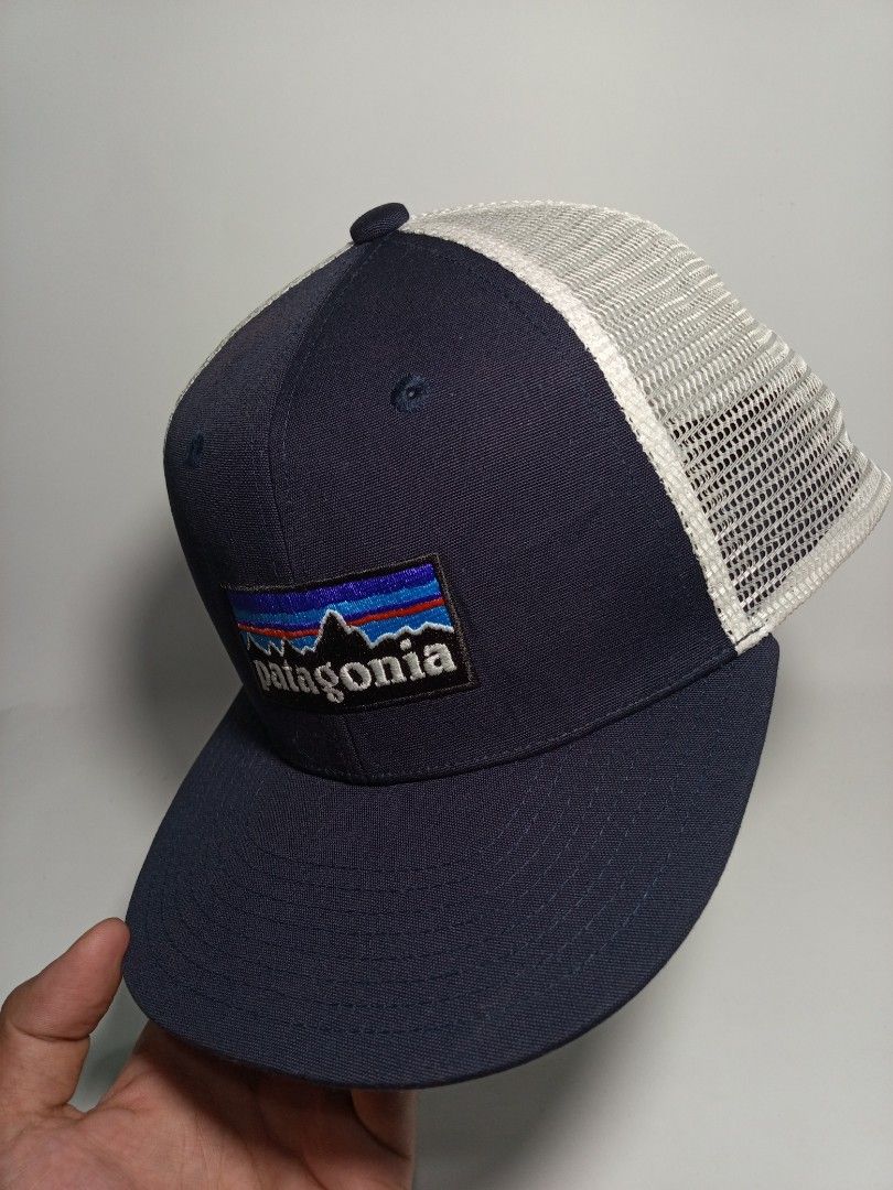 Patagonia Trucker Snapback Hat Navy Blue (Category: Caps & Hats) located in Lucena. Submitted by sanera_23 (Listing ID 1467033734, Image 2). Description: -Fits to small Adult - Brand: Patagonia - Style: Trucker hat / Snapback - Color: Navy blue with white mesh back - Details: Classic embroidered mountain logo patch on front - Closure: Adjustable snapback with brand tag - Condition: Clean interior lining with original tags attached.