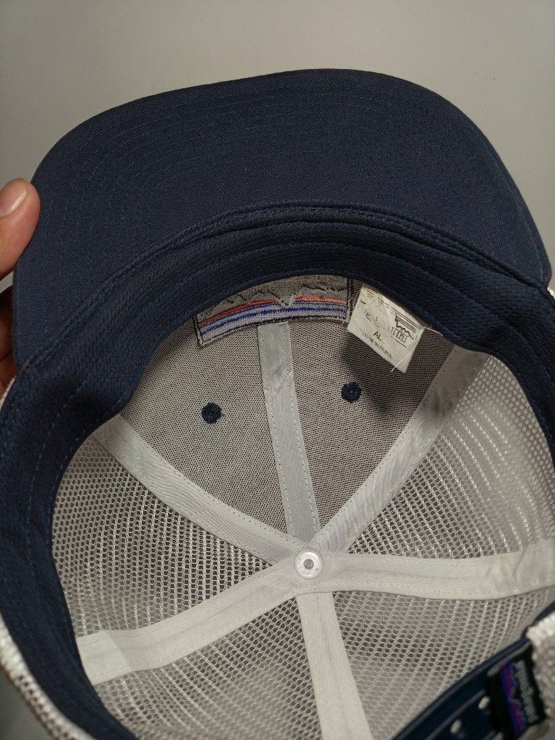 Patagonia Trucker Snapback Hat Navy Blue (Category: Caps & Hats) located in Lucena. Submitted by sanera_23 (Listing ID 1467033734, Image 3). Description: -Fits to small Adult - Brand: Patagonia - Style: Trucker hat / Snapback - Color: Navy blue with white mesh back - Details: Classic embroidered mountain logo patch on front - Closure: Adjustable snapback with brand tag - Condition: Clean interior lining with original tags attached.
