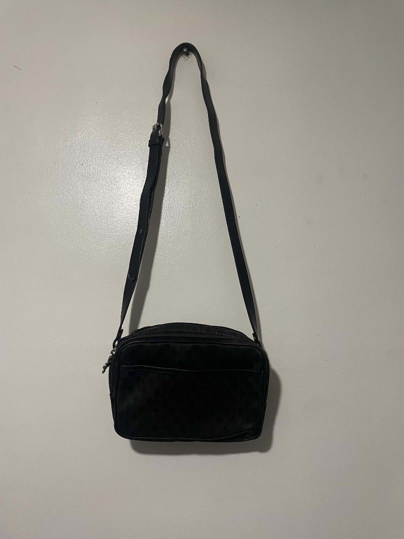 Patrick Cox Black Crossbody Bag Monogram (Category: Cross-body Bags) located in Manila. Submitted by mikeee03 (Listing ID 1467065812, Image 1). Description: - Brand: Patrick Cox - Color: Classic black with all-over fleur-de-lis monogram pattern - Material: Textured leather finish - Features: Adjustable strap, secure top zip closure, and front slip pocket with snap button - Interior: Branded fabric lining with metal logo plaque - Condition: Clean 
