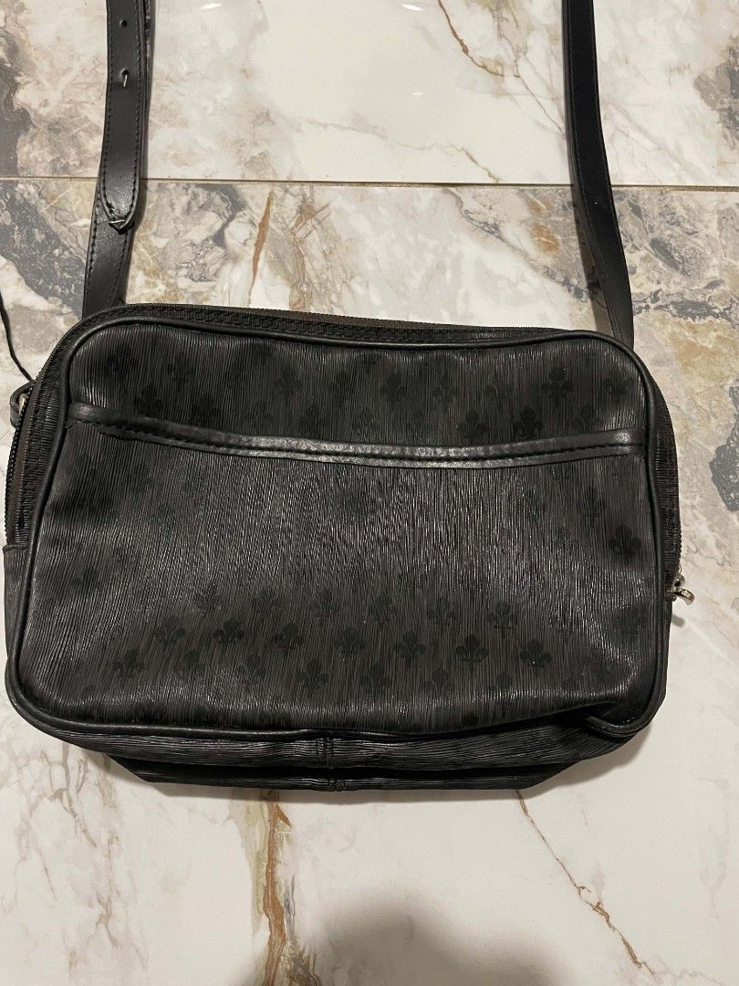 Patrick Cox Black Crossbody Bag Monogram (Category: Cross-body Bags) located in Manila. Submitted by mikeee03 (Listing ID 1467065812, Image 2). Description: - Brand: Patrick Cox - Color: Classic black with all-over fleur-de-lis monogram pattern - Material: Textured leather finish - Features: Adjustable strap, secure top zip closure, and front slip pocket with snap button - Interior: Branded fabric lining with metal logo plaque - Condition: Clean 