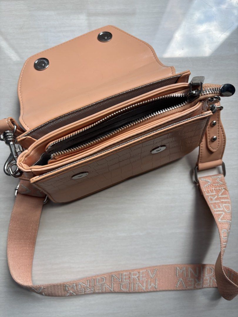 Peach Croc Pattern Crossbody Bag with Wide Strap (Category: Cross-body Bags) located in Makati City. Submitted by bittersweet818ta (Listing ID 1467155313, Image 3). Description: - Trendy peach crossbody bag with faux crocodile skin texture - Secure flap closure with snap buttons and subtle logo detail - Thick, adjustable woven strap featuring a stylish repeated text pattern - Silver-tone hardware for a modern finish - Organized interior with mult
