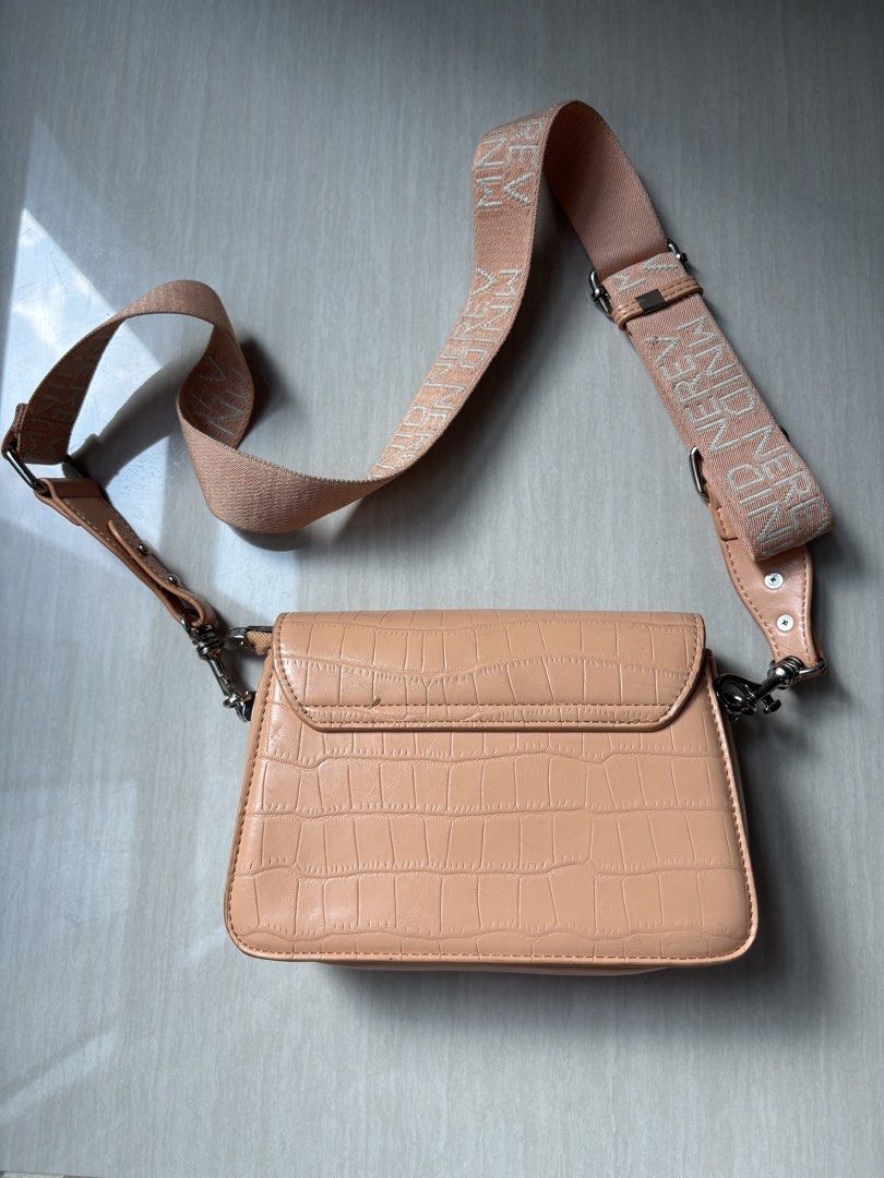 Peach Croc Pattern Crossbody Bag with Wide Strap (Category: Cross-body Bags) located in Makati City. Submitted by bittersweet818ta (Listing ID 1467155313, Image 2). Description: - Trendy peach crossbody bag with faux crocodile skin texture - Secure flap closure with snap buttons and subtle logo detail - Thick, adjustable woven strap featuring a stylish repeated text pattern - Silver-tone hardware for a modern finish - Organized interior with mult