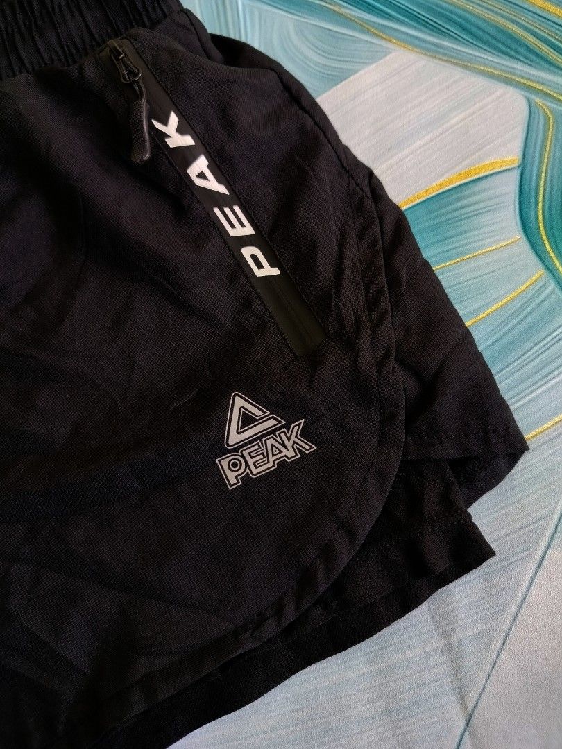 Peak Black Athletic Shorts 2XL (Category: Shorts) located in Manila. Submitted by virgiliosa38485 (Listing ID 1467114675, Image 2). Description: - Brand/Model: Black Peak Athletic Shorts - Size: 2XL (Tag 180/84A) -Waist 30-38 -Length 11 - Material: 100% Polyester (fabric and lining) - Storage: Secure zippered pockets on both sides - Fit: Elastic waistband with adjustable drawstring - Comfort: Built-in inner lining for extra coverage and support -