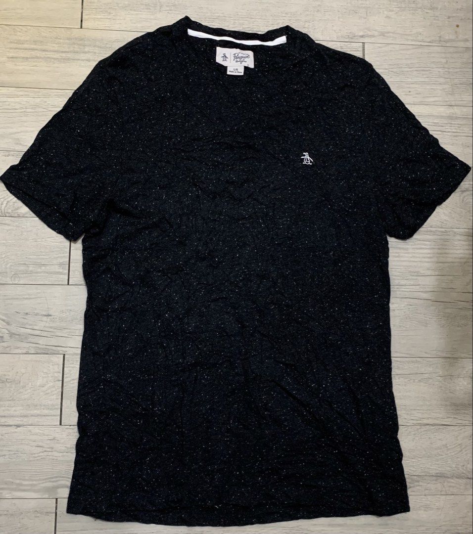 Penguin Shirt (Category: Activewear) located in Manila. Submitted by sgthriftmanila2.0 (Listing ID 1467064773, Image 3). Description: PTPA 🙏 The image shows a black speckled crewneck t-shirt by Original Penguin by Munsingwear with a small embroidered penguin logo on the chest. Size: Medium 20x29.5 Condition: like new Colorate: 9 or up/10 Made: China Issue: Need wash only DM 📥 Sucat, Paranaque city.