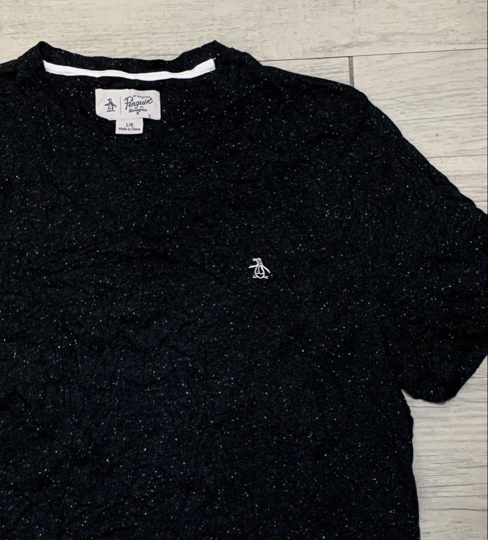 Penguin Shirt (Category: Activewear) located in Manila. Submitted by sgthriftmanila2.0 (Listing ID 1467064773, Image 1). Description: PTPA 🙏 The image shows a black speckled crewneck t-shirt by Original Penguin by Munsingwear with a small embroidered penguin logo on the chest. Size: Medium 20x29.5 Condition: like new Colorate: 9 or up/10 Made: China Issue: Need wash only DM 📥 Sucat, Paranaque city.