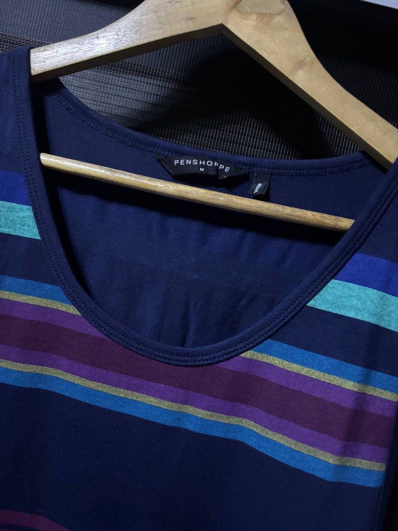 Penshoppe Striped Tank Top (Category: Activewear) located in Pasig City. Submitted by abogadosupremo (Listing ID 1467032368, Image 2). Description: - Brand: Penshoppe - Color: Navy blue with purple, green, and blue horizontal stripes - Material: Lightweight cotton - Fit: Standard fit with scoop neckline and sleeveless cut - Condition: Clean inside and out, from a smoke-free home - Ideal for: Casual wear, summer days, or gym workouts - 100% Legit 